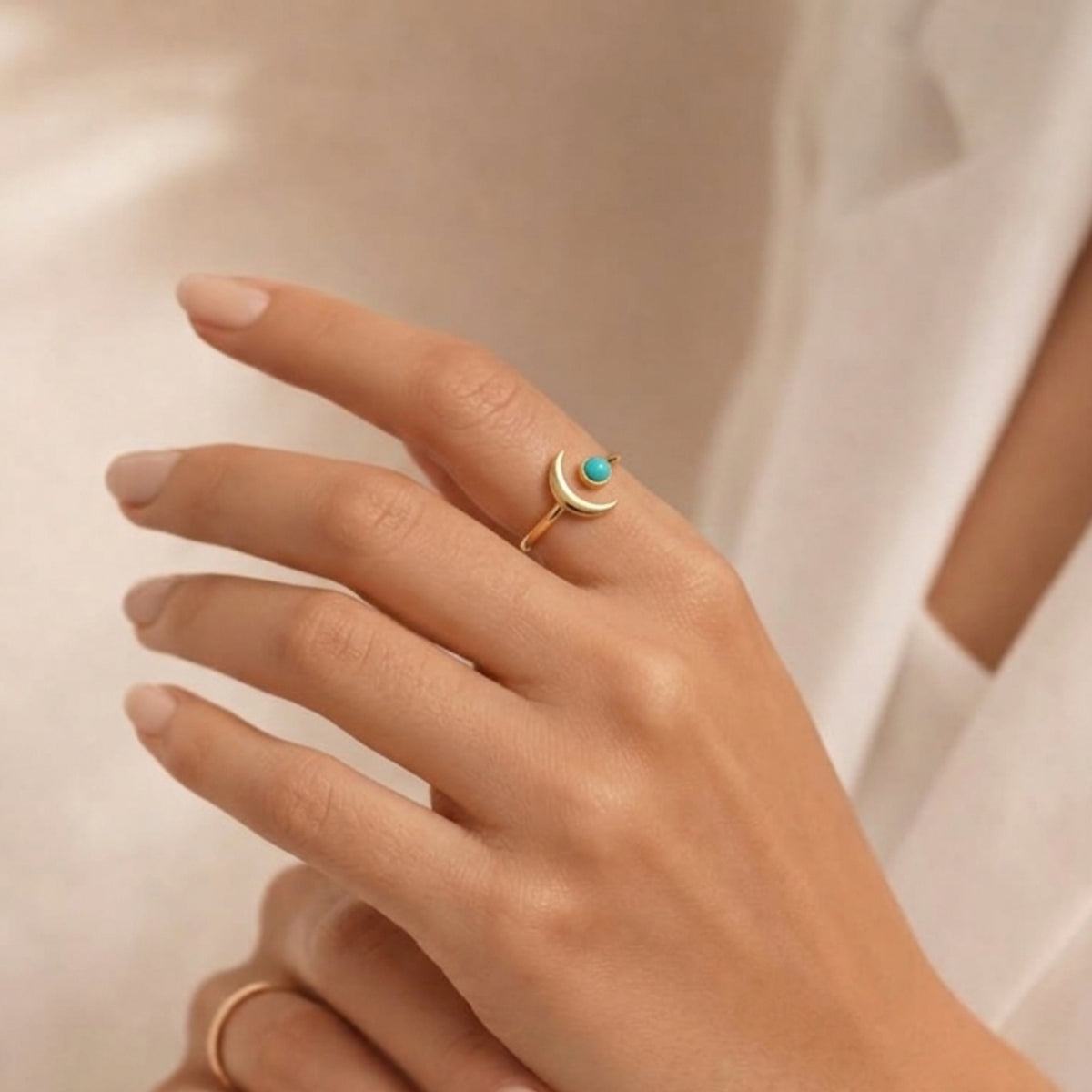 Detalle del Anillo Aylin: la luna y la turquesa vistas de cerca en el dedo